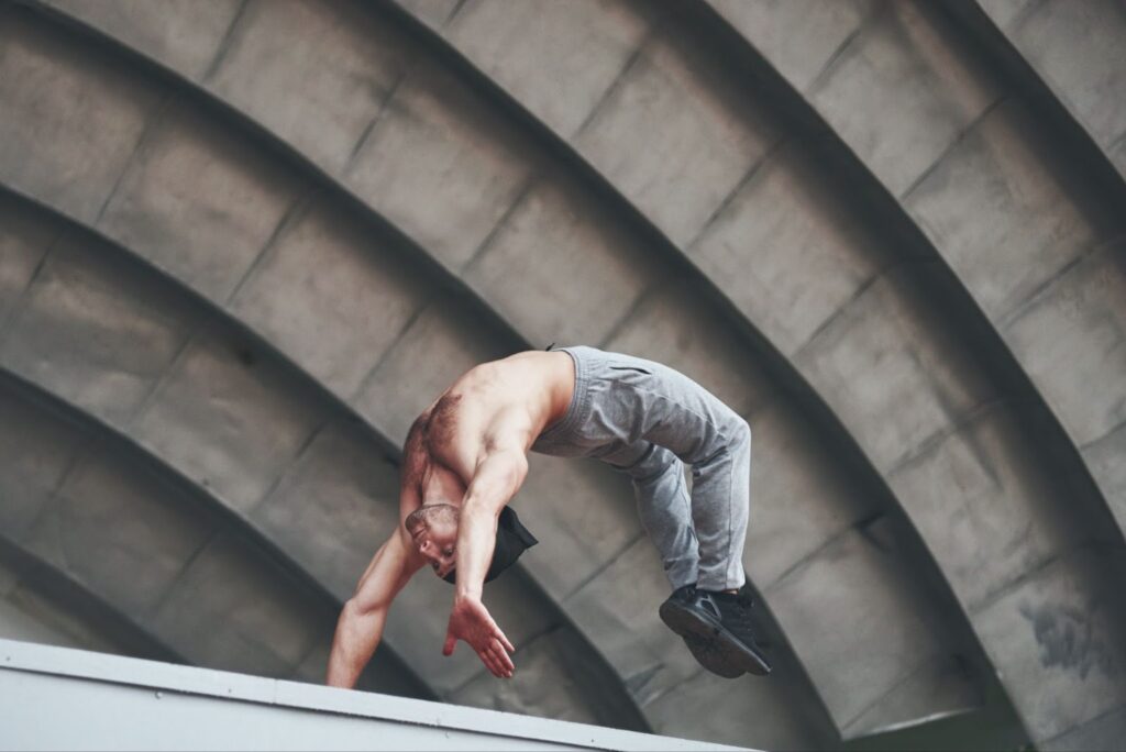 Man in the open air practices backflip
