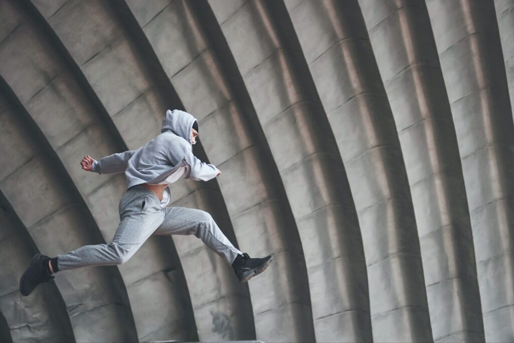 Man outdoors practices parkour