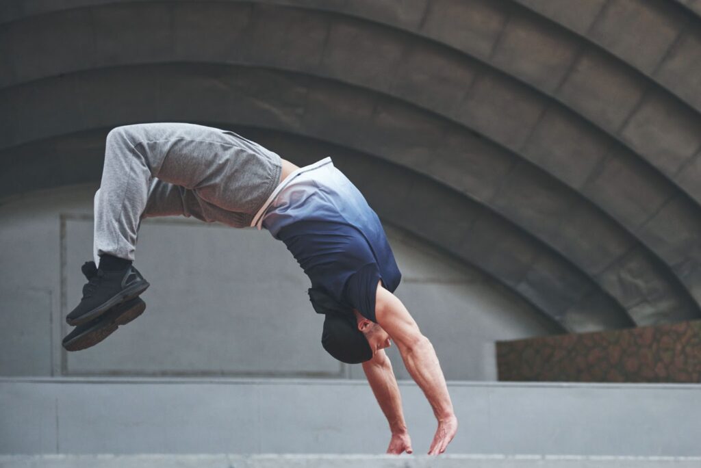 Man outdoors practices parkour